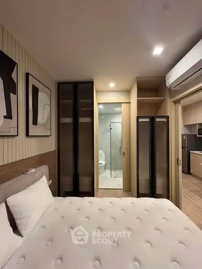 Modern bedroom with ensuite bathroom and sleek storage solutions
