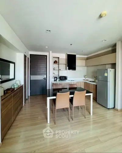 Modern kitchen with sleek cabinets and dining area in stylish apartment