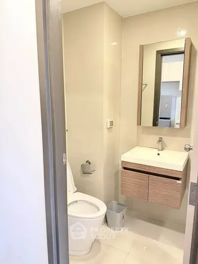 Modern bathroom with sleek fixtures and minimalist design in a contemporary apartment.