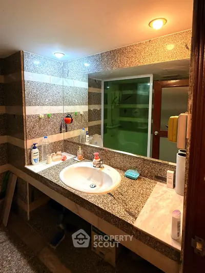 Spacious bathroom with granite countertop and modern lighting