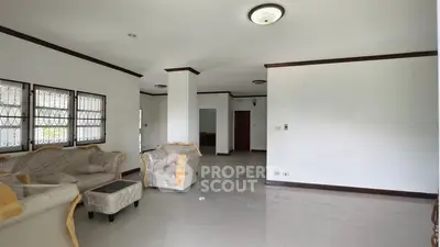 Spacious living room with elegant furniture and large windows for natural light.