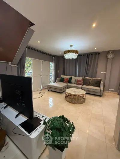 Spacious living room with elegant decor and large windows for natural light.