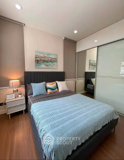 Modern bedroom with stylish decor and cozy ambiance, featuring a comfortable bed and elegant furnishings.