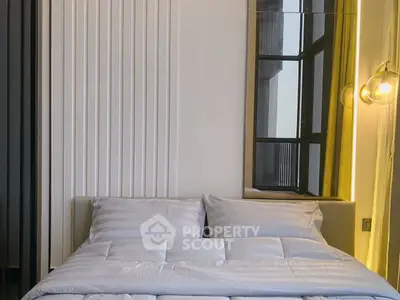 Modern bedroom with stylish lighting and large window