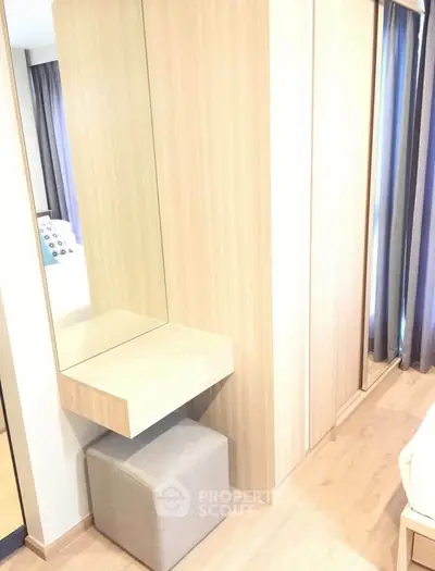 Modern bedroom with stylish wooden wardrobe and cozy seating area