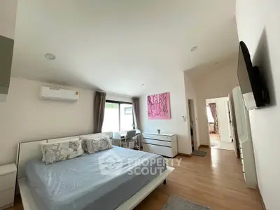 Spacious modern bedroom with stylish decor and natural light
