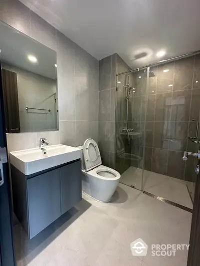 Modern bathroom with sleek design, glass shower, and contemporary fixtures.