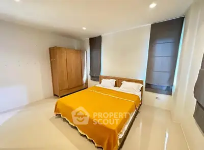 Spacious bedroom with modern decor and ample natural light