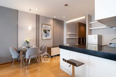 Modern kitchen with sleek design, open layout, and stylish dining area in a contemporary apartment.