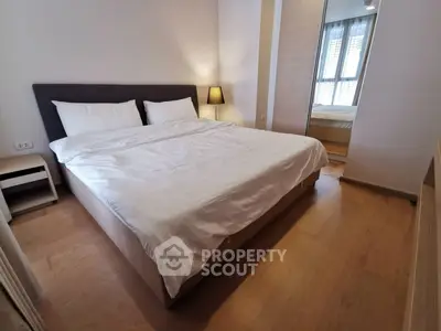 Spacious bedroom with modern decor and ample natural light
