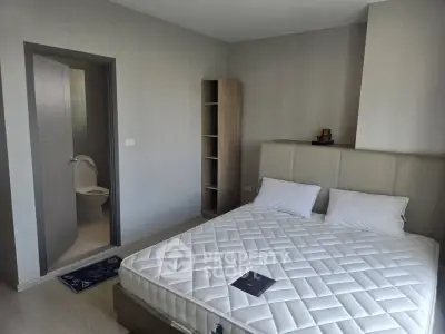 Modern bedroom with ensuite bathroom and minimalist decor in a stylish apartment.