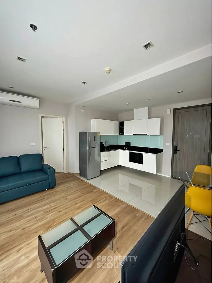 Modern open-plan living room with sleek kitchen and stylish furnishings