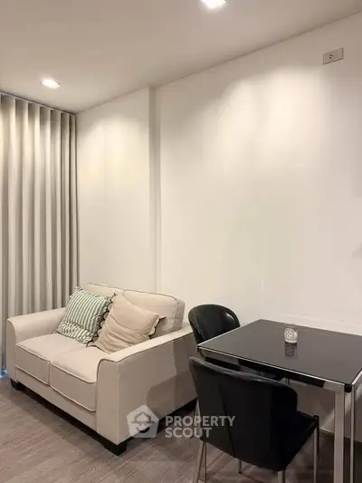 Modern living room with cozy sofa and dining table in a stylish apartment.