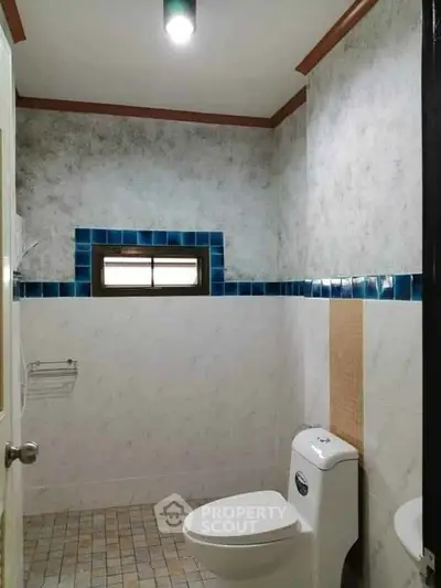 Compact bathroom with modern fixtures and tiled walls