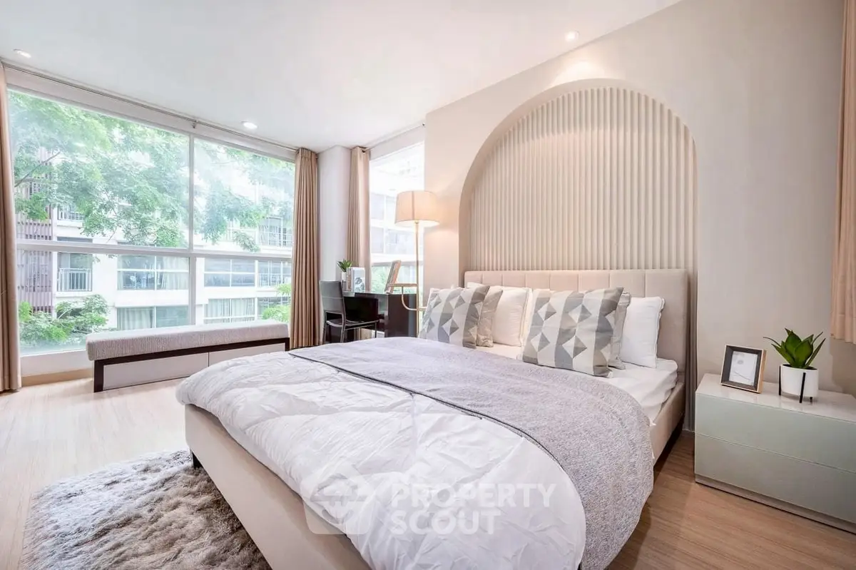 Spacious modern bedroom with large windows and elegant decor