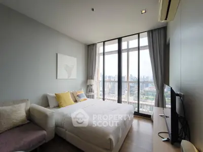 Modern bedroom with city view, large windows, and stylish decor in a high-rise apartment.