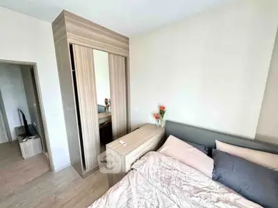 Cozy bedroom with modern wooden wardrobe and stylish decor
