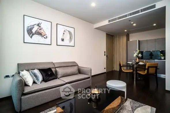 Modern living room with stylish decor and open kitchen layout in a contemporary apartment.