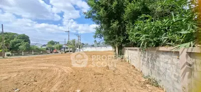 Spacious land plot with potential for development under clear blue skies.