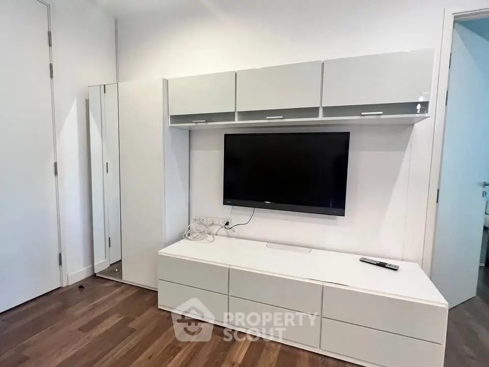 Modern living room with sleek TV unit and storage cabinets, perfect for contemporary homes.
