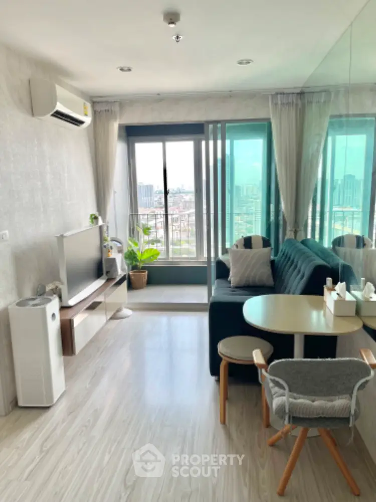 Modern living room with city view, stylish furniture, and large windows for natural light.