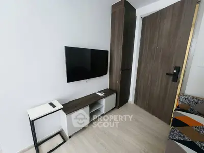 Modern minimalist living room with wall-mounted TV and sleek furniture
