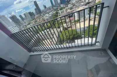 Stunning city view from a high-rise balcony with sleek railing and spacious layout.