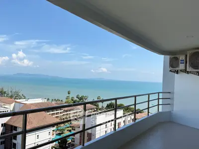 Stunning ocean view from spacious balcony in modern apartment complex.