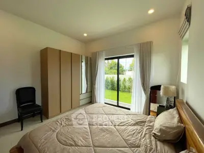 Spacious bedroom with garden view and modern furnishings