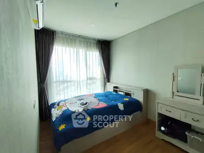 Cozy bedroom with large window and stylish furniture in modern apartment.