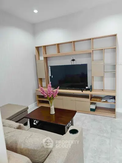 Cozy living room with modern TV unit and comfortable seating
