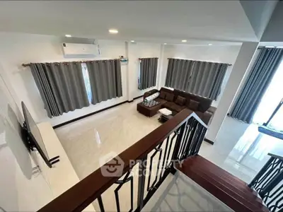 Spacious living room with modern decor and large windows for natural light.
