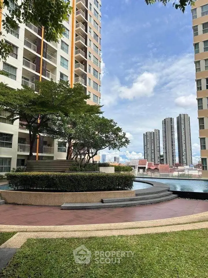 Stunning residential complex with lush greenery and modern architecture, offering serene urban living.
