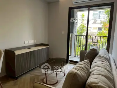 Modern living room with cozy sofa and balcony view in urban apartment.