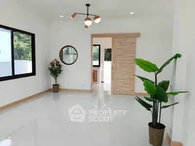 Spacious modern living room with large window and stylish decor