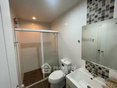 Modern bathroom with glass shower and sleek fixtures