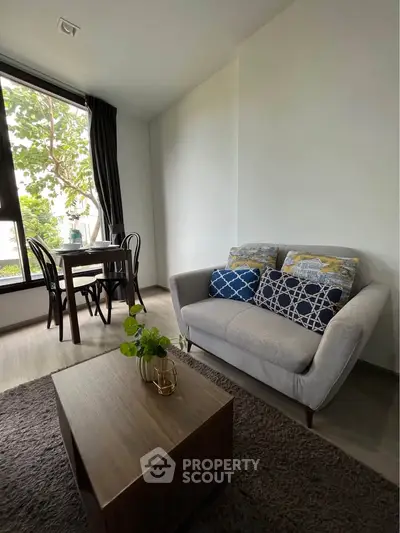 Cozy living room with modern decor and large window view