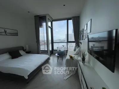 Luxurious bedroom with stunning city view and modern decor, featuring a large window and elegant furnishings.