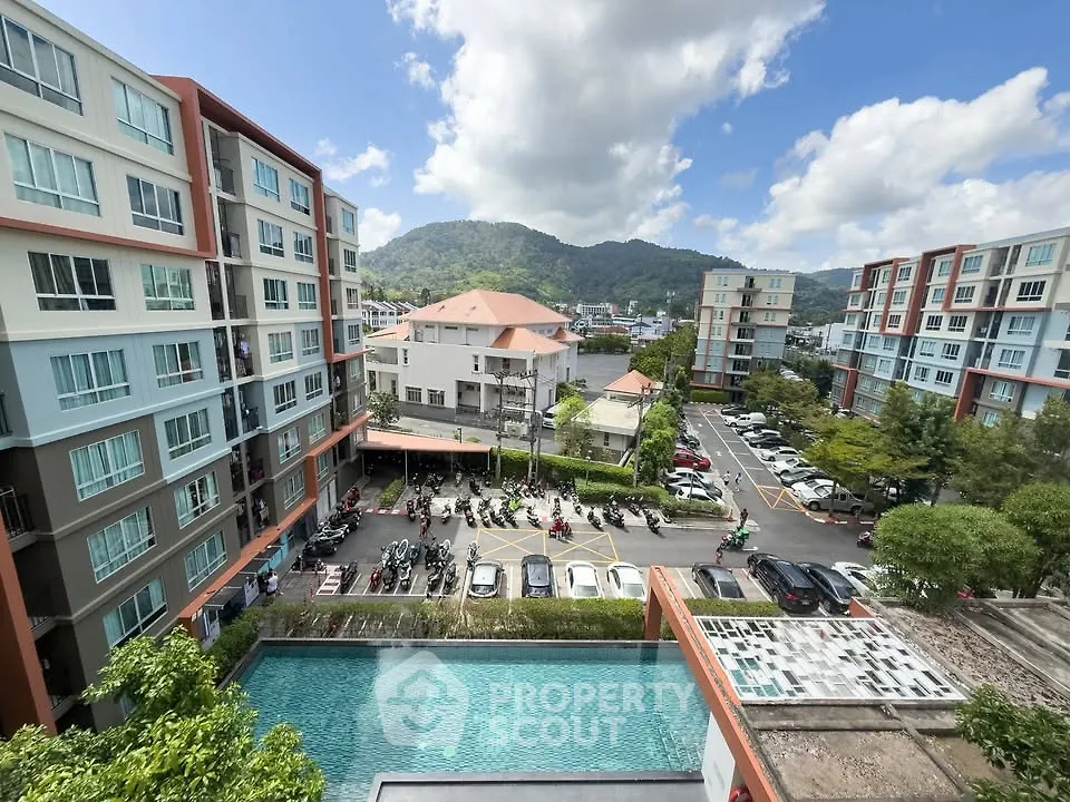 Stunning view of modern apartment complex with pool and mountain backdrop