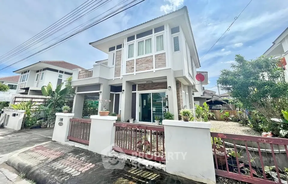 Charming two-story house with modern design and lush garden in a serene neighborhood.