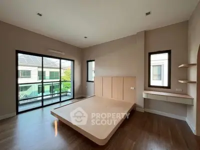 Spacious bedroom with modern design and large windows offering natural light.