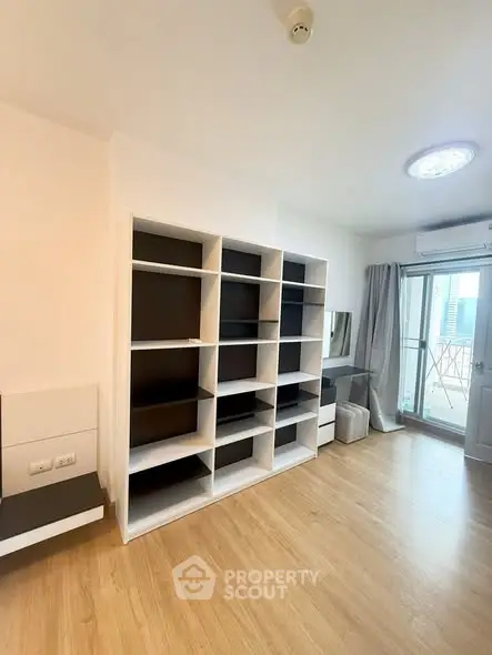 Modern apartment interior with stylish shelving and balcony access