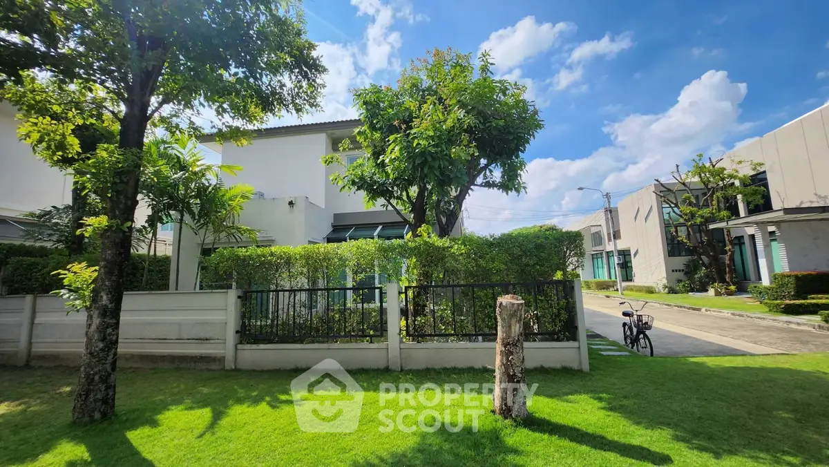 Charming suburban home with lush garden and clear blue sky