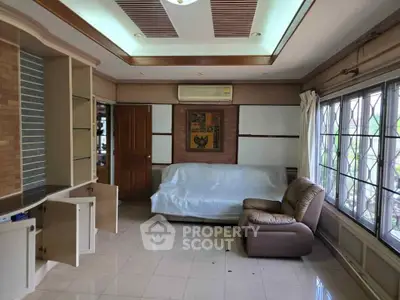 Spacious living room with large windows and comfortable seating