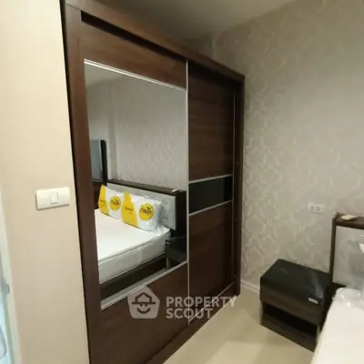 Modern bedroom with stylish wardrobe and elegant decor, perfect for comfortable living.