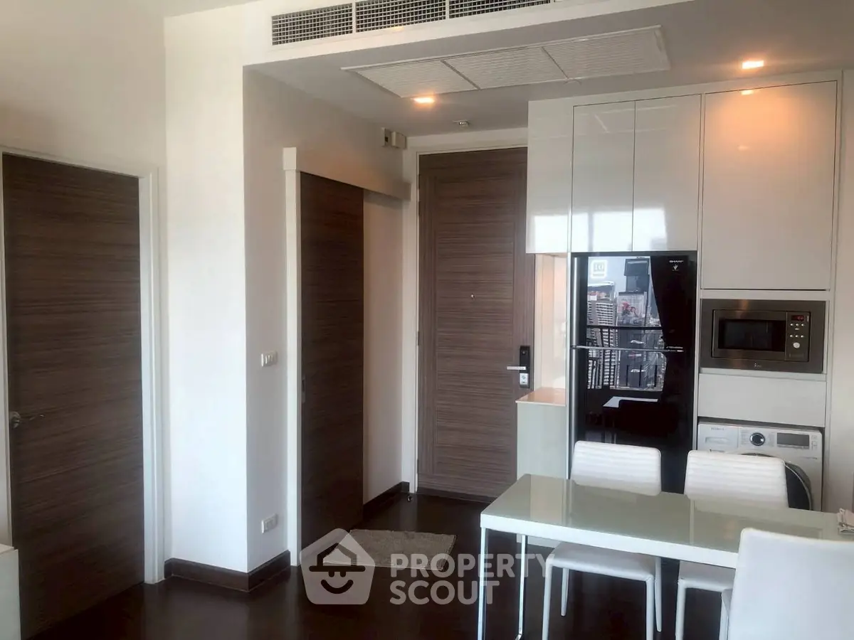 Modern apartment interior with sleek kitchen appliances and dining area
