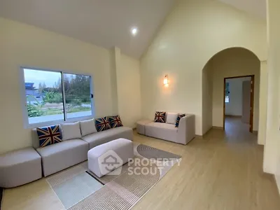 Spacious living room with modern decor and large window view