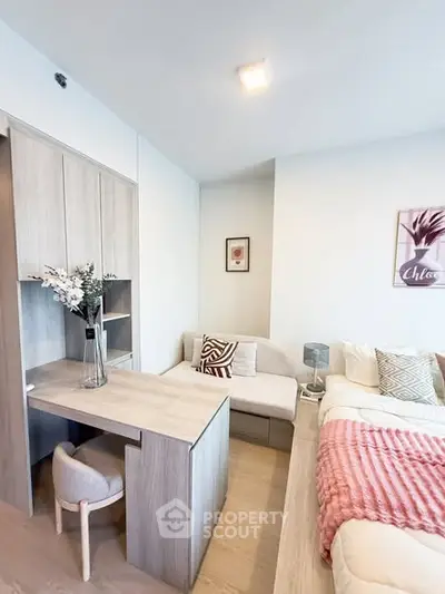 Modern bedroom with stylish decor and cozy seating area, perfect for relaxation and comfort.