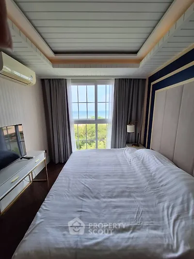 Luxurious bedroom with large window and elegant decor