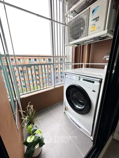 Modern balcony with washing machine and air conditioning unit in urban apartment.